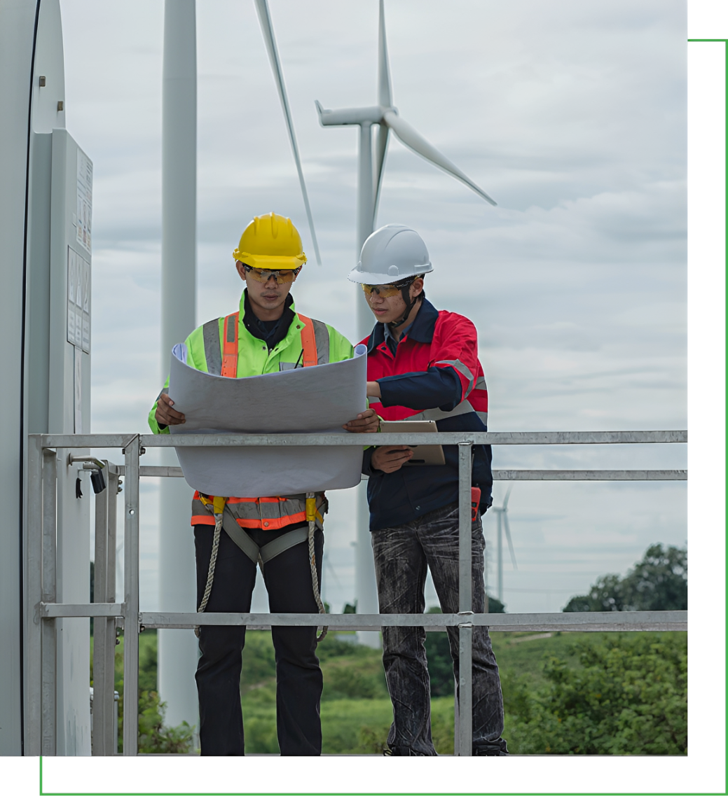 Engineers reviewing plans at wind farm