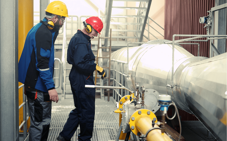 Workers in protective gear at a facility